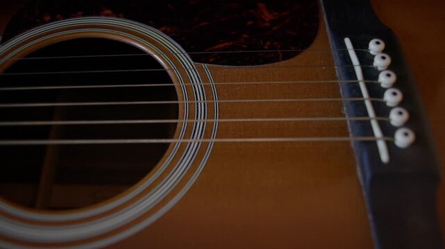 Close Up of Acoustic Guitar Sound Hole and Body During Cleaning Shot with Cinema Camera