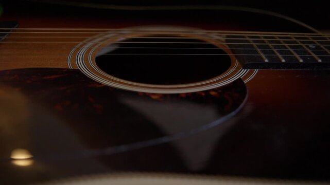 Cleaning Acoustic Guitar Body with Microfiber Cloth Close Up Shot with Cinema Camera