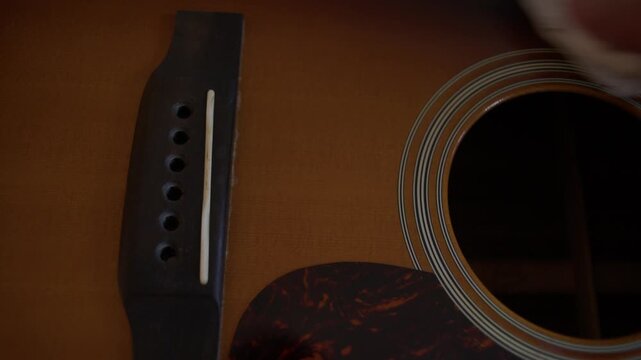Detailed Cleaning of Acoustic Guitar Bridge and Saddle Before Restringing Shot with Cinema Camera