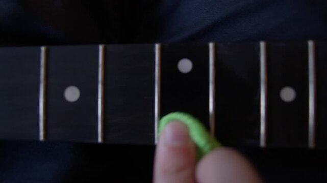 Close Up Cleaning Acoustic Guitar Fretboard Before Installing New Strings Shot