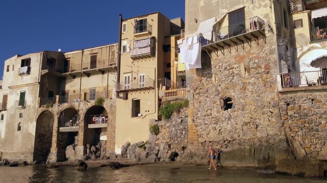Weathered Stone Houses Built Above Sea Wall in Cefalu Old Town