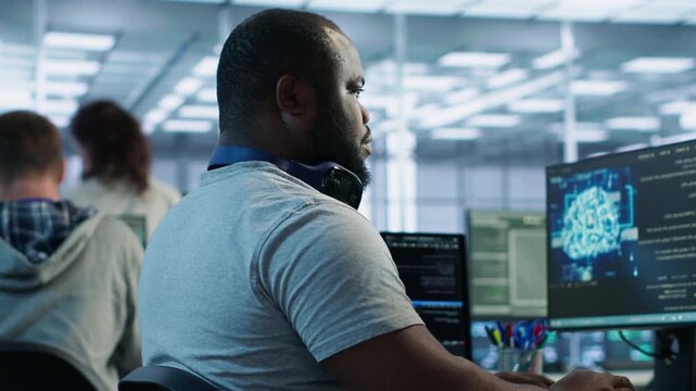 Happy engineer laughing at coworker joke while operating in high tech AI facility as showing secure storage, threat prevention and cybersecurity monitoring.