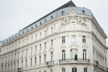 Fototapeta premium Ornate white historic building with mansard roof and decorative facade