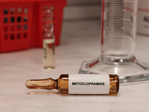 METOCLOPRAMIDE dopamine antagonist for nausea and gastric motility disorders in an injectable vial medical ampoule on a clinical laboratory table