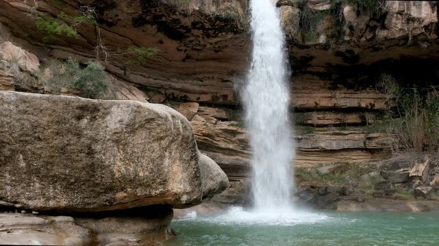 Footage of Salto de La Portellada waterfall on cloudy day. Teruel, Aragon, Spain.