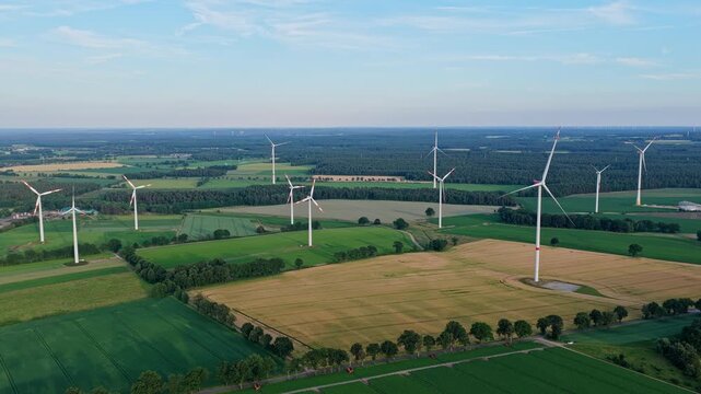 Offshore wind park. Wind turbines farm. Alternative renewable energy generation. Green energy concept. Organic harvest in farm field. Agricultural harvest. Crop cultivation
