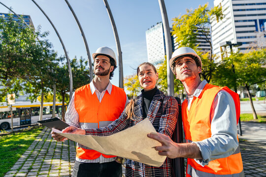Business coworking team reviewing city construction plan