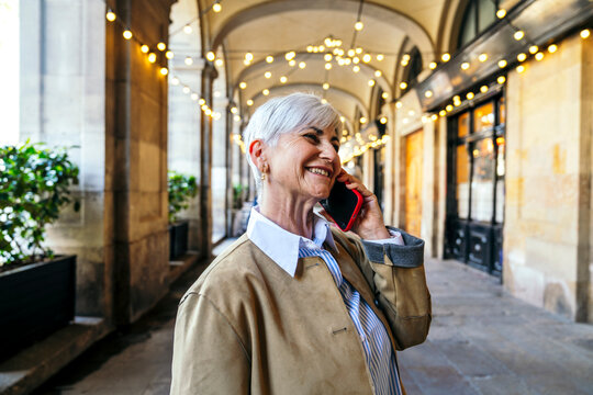 Senior woman enjoying a phone call during travel