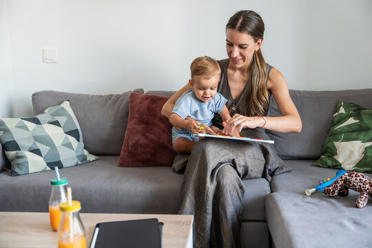 Mother and son learning alphabet with magnetic letters
