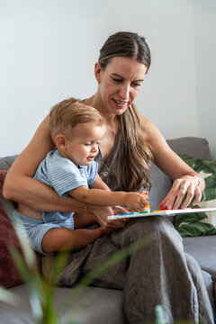 Mother and son learning alphabet with magnetic letters