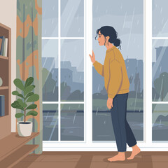 Fototapeta premium Person checking weather while standing barefoot by the window during rainy day