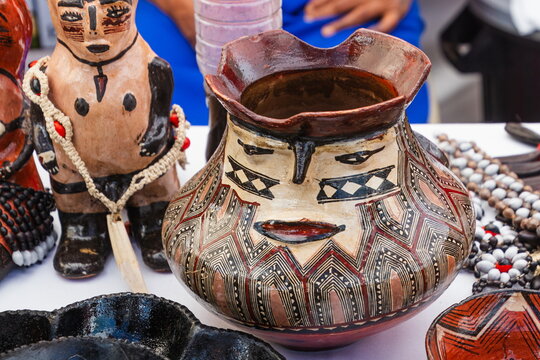 A traditional Amazonian ceramic tinaja (jar) handcrafted by the Kichwa (Quichua) women from the Pastaza region of Ecuador is decorated with stylized images of faces and geometric patterns. 