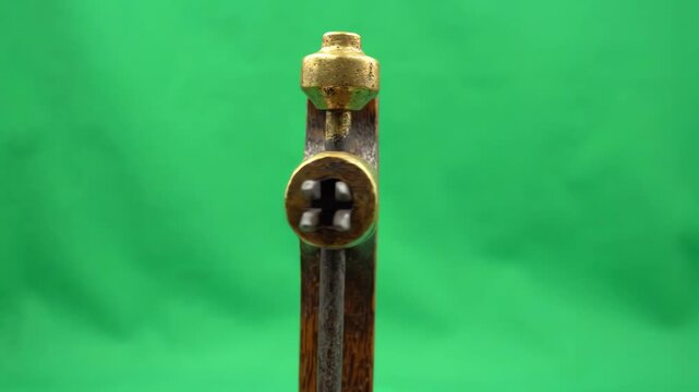 Vintage wooden mortise gauge rotating slowly against a bright green screen background for chroma key compositing