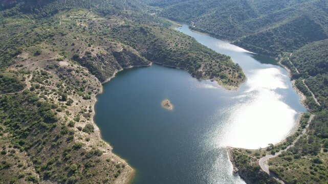 Rising up aerial shot of Siurana Reservoir on sunny summer day. Tarragona, Spain.