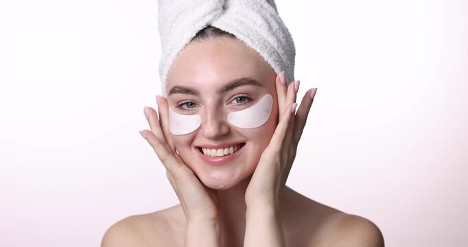 Beautiful woman with eye patches on white background