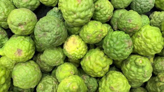 Close-up video of fresh kaffir limes in a market