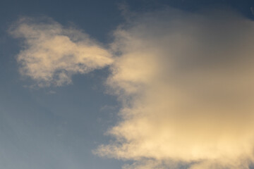 Obraz premium Golden Clouds Against Blue Sky
