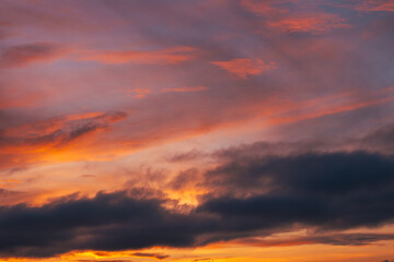 Fototapeta premium Dramatic Sunset Sky with Orange and Purple Clouds