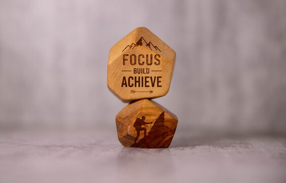 Focus Build Achieve &ndash; Motivational Success Concept on Wooden Blocks.