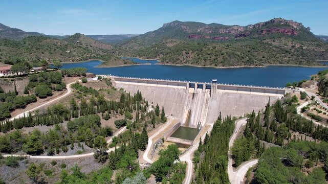 Tilt down aerial shot of Siurana dam and Reservoir on sunny summer day. Tarragona, Spain.