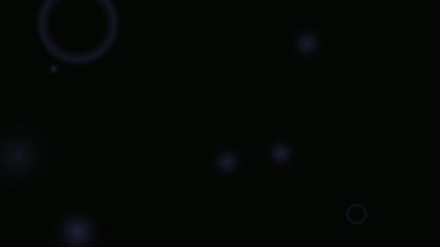 A seamless looping video background featuring a large purple ring and smaller glowing orbs floating in the darkness.