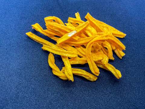 A pile of crispy, golden-yellow Punjabi Tadka Namkeen and seasoned soya sticks, a popular traditional Indian tea-time savory snack. These crunchy 