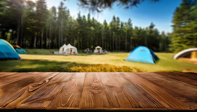 Empty Wooden Picnic Table With A Blurred Forest Campsite And Tents In The Background