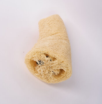Natural loofah sponge with visible fibrous interior isolated on white background
