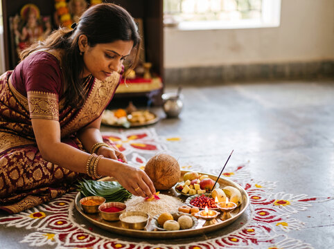 Woman Preparing Traditional Puja Offerings on a Decorative Ritual Tray During Durga Puja