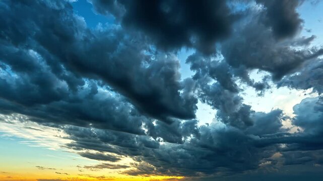 Dramatic time lapse of dark storm clouds rolling over golden sunset