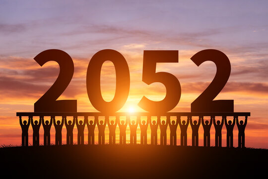 Numerous small figures silhouette in the morning sun, holding 2052