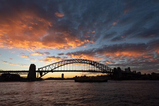 Sydney Harbour bridge silhouetted against the sky just after sunset. Sydney, New South Wales, Australia.