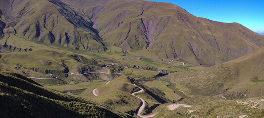 Winding Switchback Road Through Green Mountain Landscape © celu
