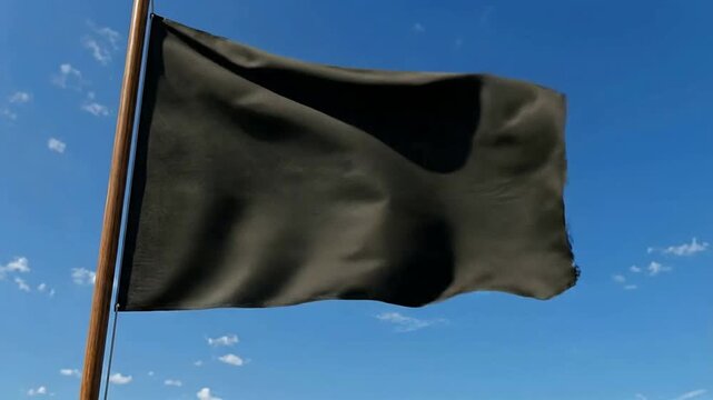 Black Flag Flapping in Wind Against a Bright Blue Sky