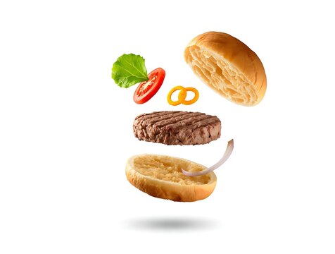 Exploded view of a delicious grilled beef burger with fresh ingredients.