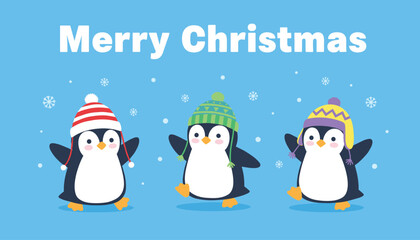 Obraz premium Three cheerful cartoon penguins wearing colorful winter hats celebrate under a merry christmas message on blue.