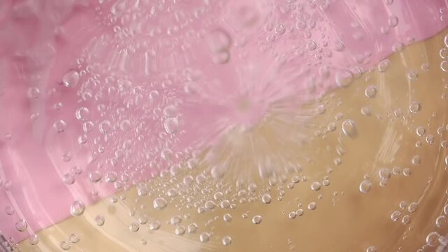 Bubbles rise in a glass container on a surface