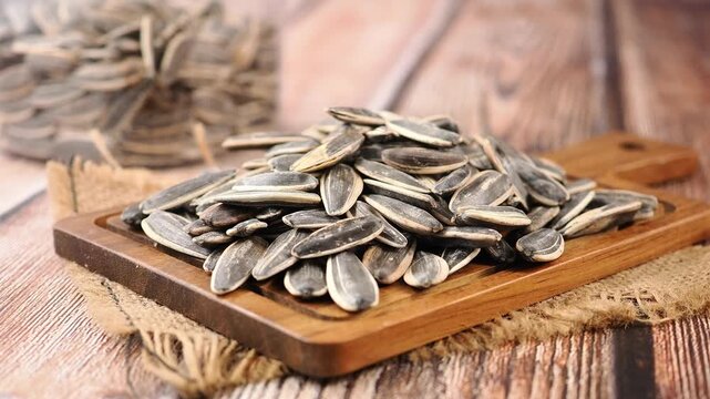 Sunflower seeds on wooden board at kitchen table