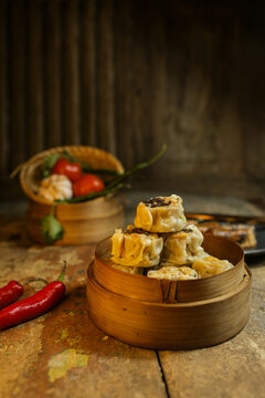 baked potatoes with mushrooms Steamed Shumai Dumplings in Bamboo Basket on Rustic Wooden Table