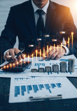 Businessman Analyzing Financial Growth with Digital Data Overlay and Stacks of Coins for Investment Success and Economic Strategy