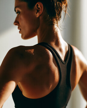 Athletic woman looking over shoulder after intense training