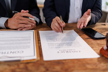 Legal professionals or business partners engaging in an important discussion. Reviewing documents....