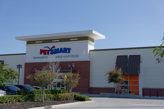 PetSmart storefront showing grooming and self dog wash signage above the entrance. Editorial Use Only July 23, 2026 St. Petersburg,FL USA. Landscaped frontage and parking lot under a clear blue sky, c