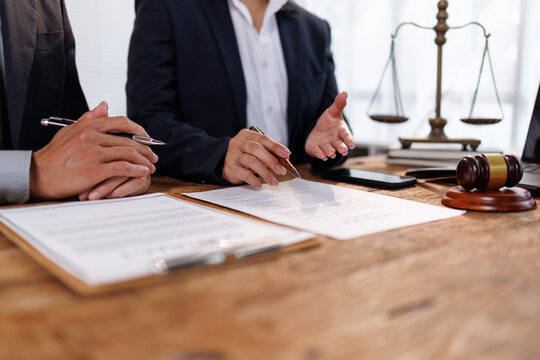Lawyers reviewing and discussing important legal documents, providing professional advice on contracts, and planning corporate strategies in a modern law office setting