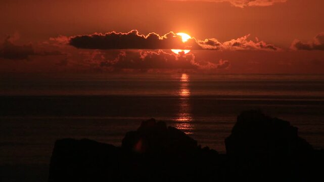 奄美大島の夏の夕日 黄金色に染まる海とリーフの海岸風景
