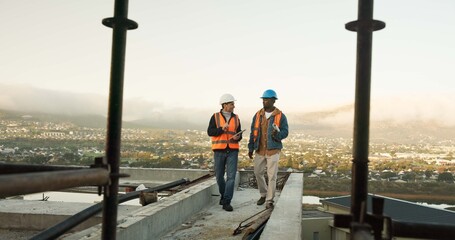 Naklejka premium Outdoor, construction and men on rooftop for talking, meeting and building update for architecture. Engineering, contractor and people in conversation for site maintenance, planning or infrastructure