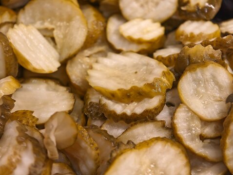 Close-up detail of stacked crinkle-cut pickle slices.
