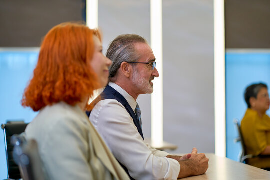 Senior Business Executive and Professional Colleagues Attending Strategic Corporate Seminar and Educational Workshop in Modern Office Conference Room