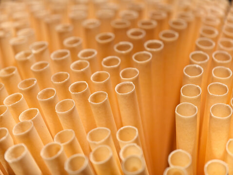 close-up pale yellow paper straws pattern.