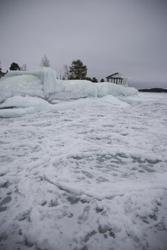 Dramatic ice formations covering a wooden gazebo on the shore of Lake Vnern, Sweden, caused by freezing spray and waves during a harsh scandinavian winter storm near amal.